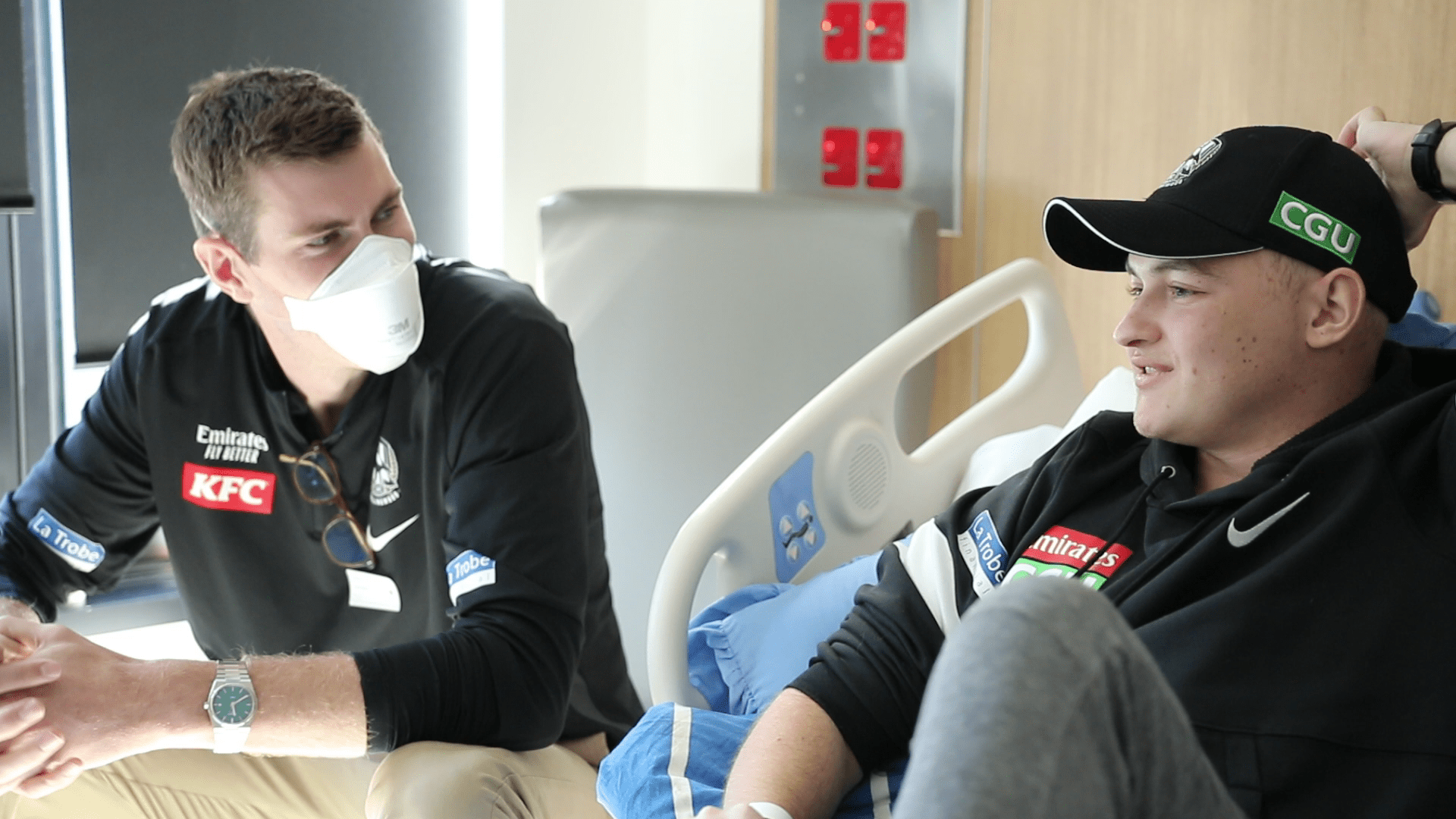Mason Cox talking with a Peter Mac patient - The AFL's Big Texan visits Peter Mac