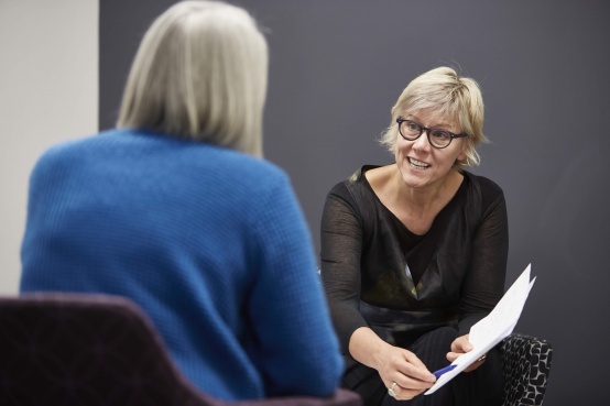Associate Professor Alison Trainer talks to a patient at the Parkville Familial Cancer Centre.